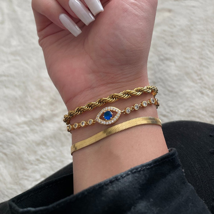 Gold plated bracelets on model hand. 