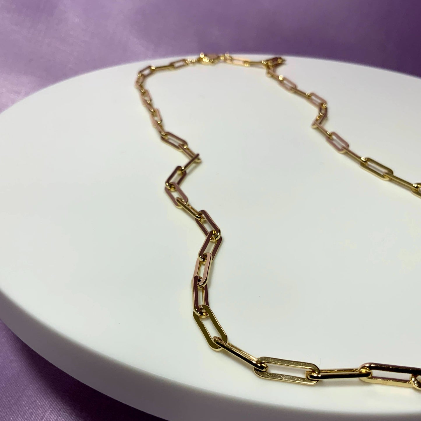 cute gold plated necklace. paper clip necklace. close up necklace display. cute gold plated necklace. paper clip necklaces. In style necklaces. trendy necklaces.