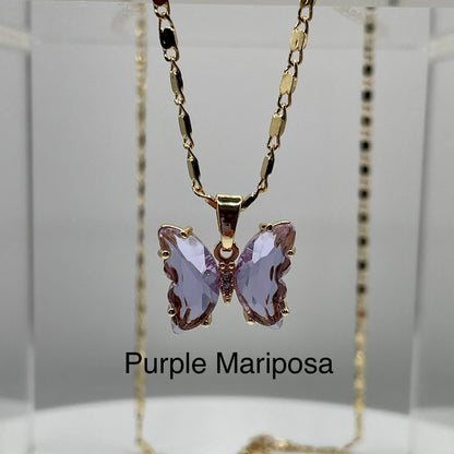 Purple butterfly pendant on gold necklace displayed on an acrylic base. Butterfly pendant. iridescent butterfly pendant. Mariposa pendant. Gold plated pendants.