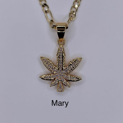 Marijuana gold plated pendant being displayed. Marihuana pendant.