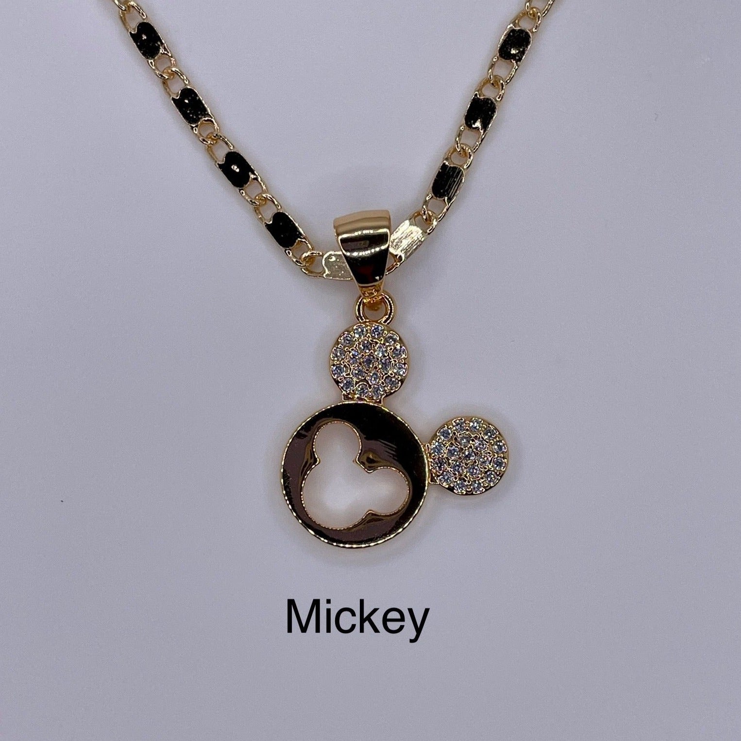 Mickey mouse pendant being displayed. Gold plated mickey mouse pendant.